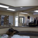 Two men talking during pharmacy construction - pre-lease inspection phase
